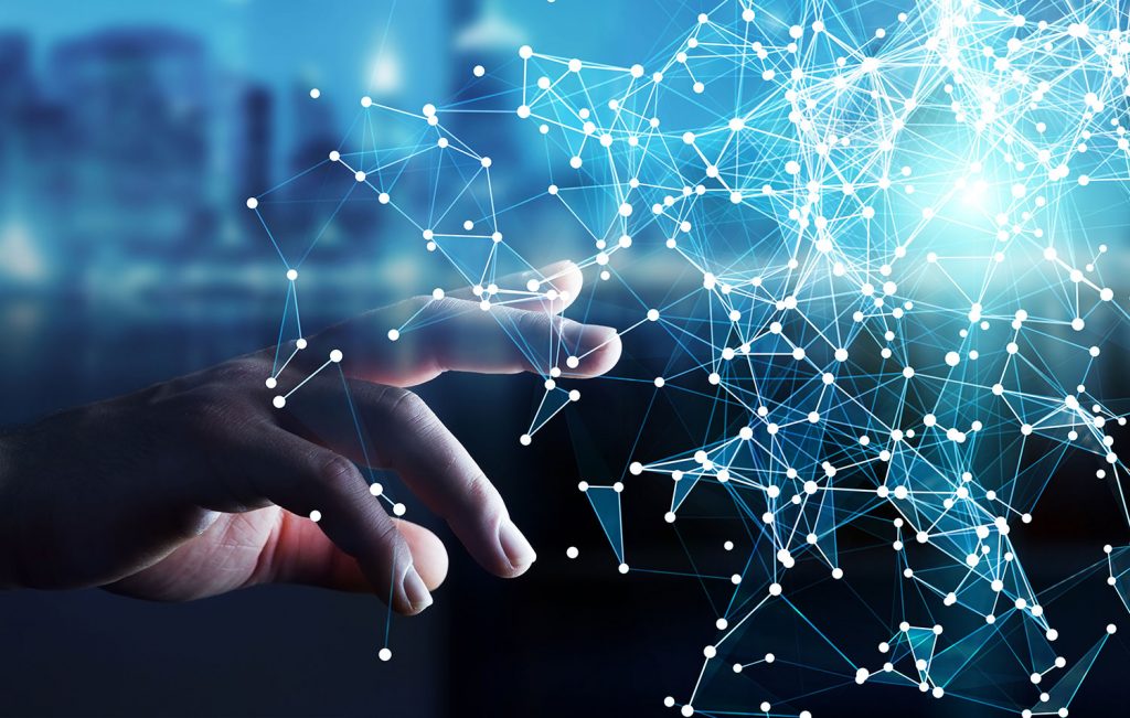 A man reaching out to touch a glowing, wireframe network connection.